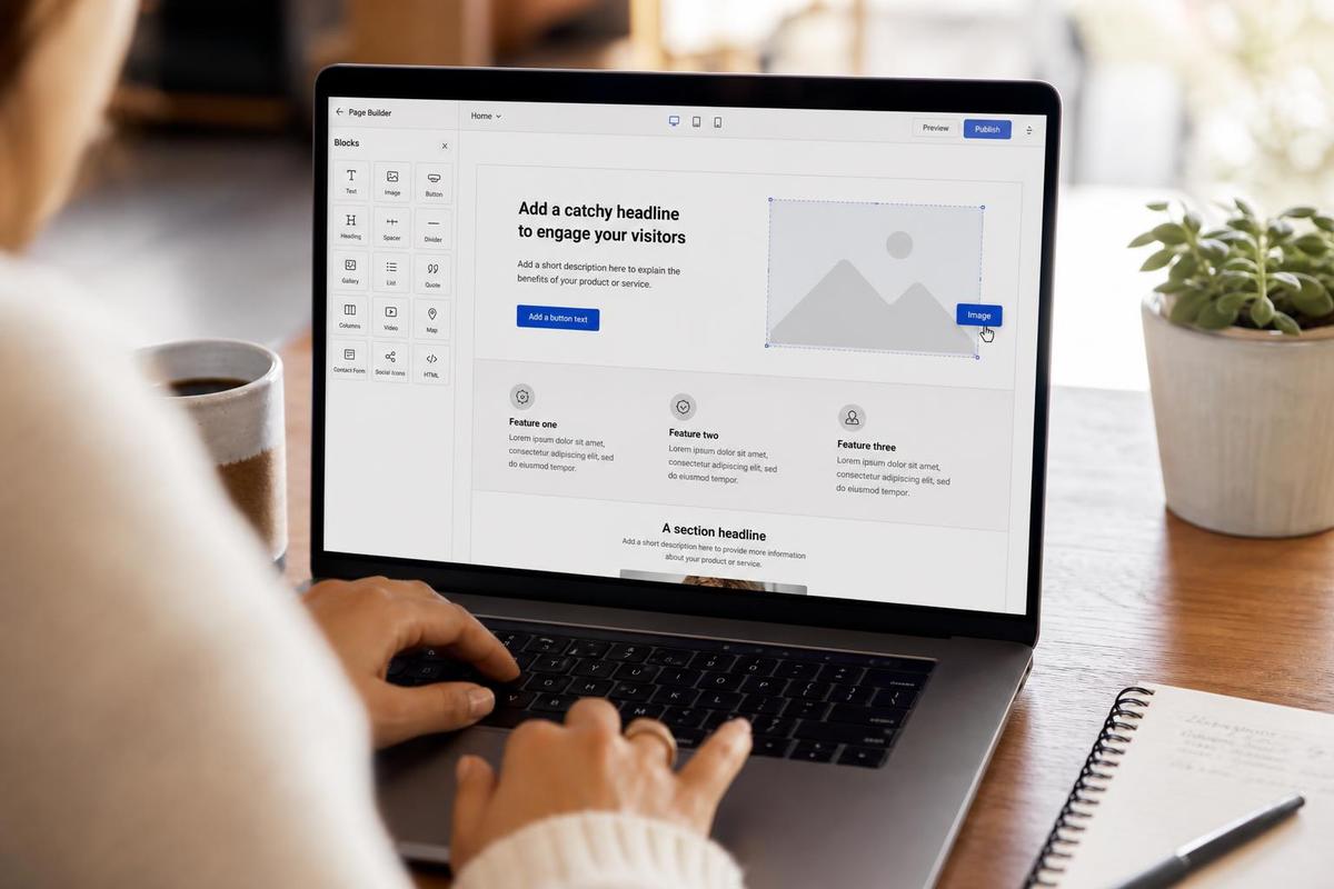 A small business owner's hands building a simple one-page website layout on a laptop using a drag-and-drop page builder